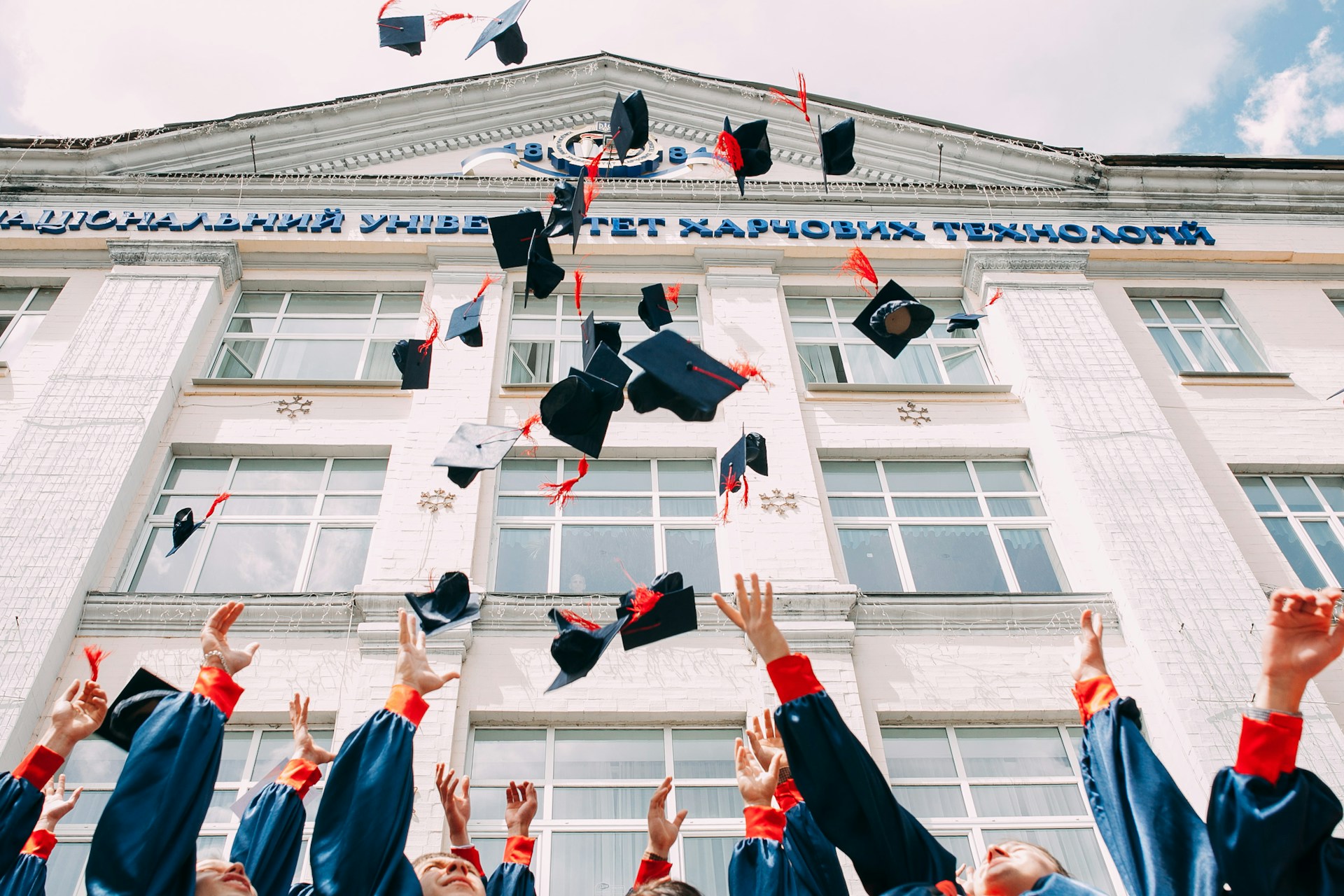 A picture of caps being thrown above, as a symbol of graduating and entering into being in your 20s.